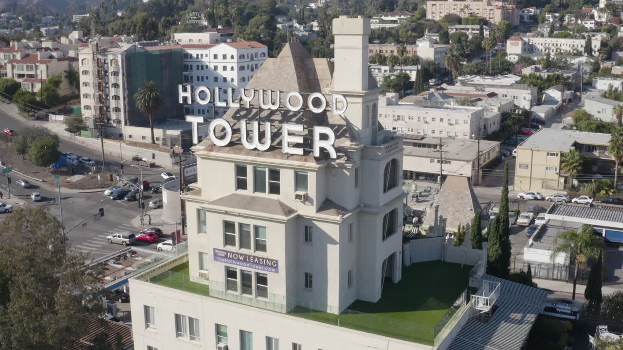 Slow aerial dolly around the Hollywood Tower Apartments in Los Angeles.