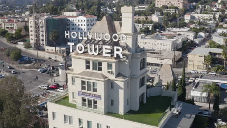 slow aerial dolly around the hollywood tower apartments in los angeles.