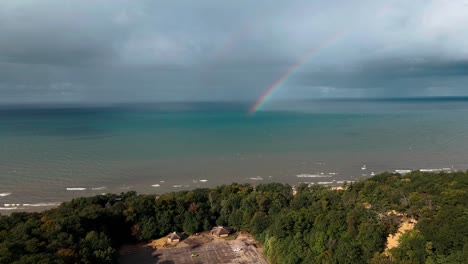 a rare double rainbow formed over lake michigan after a light storm