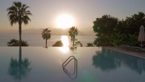 a steadicam shot of a glossy open pool surface on a sunset