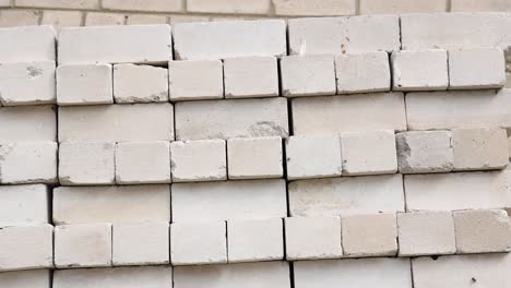 Pan-up-of-a-pallet-full-of-white-bricks