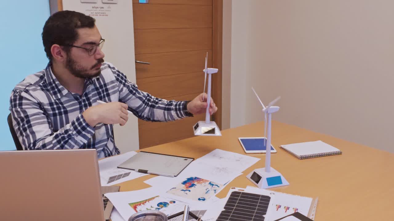 Man working on renewable energy models and designs