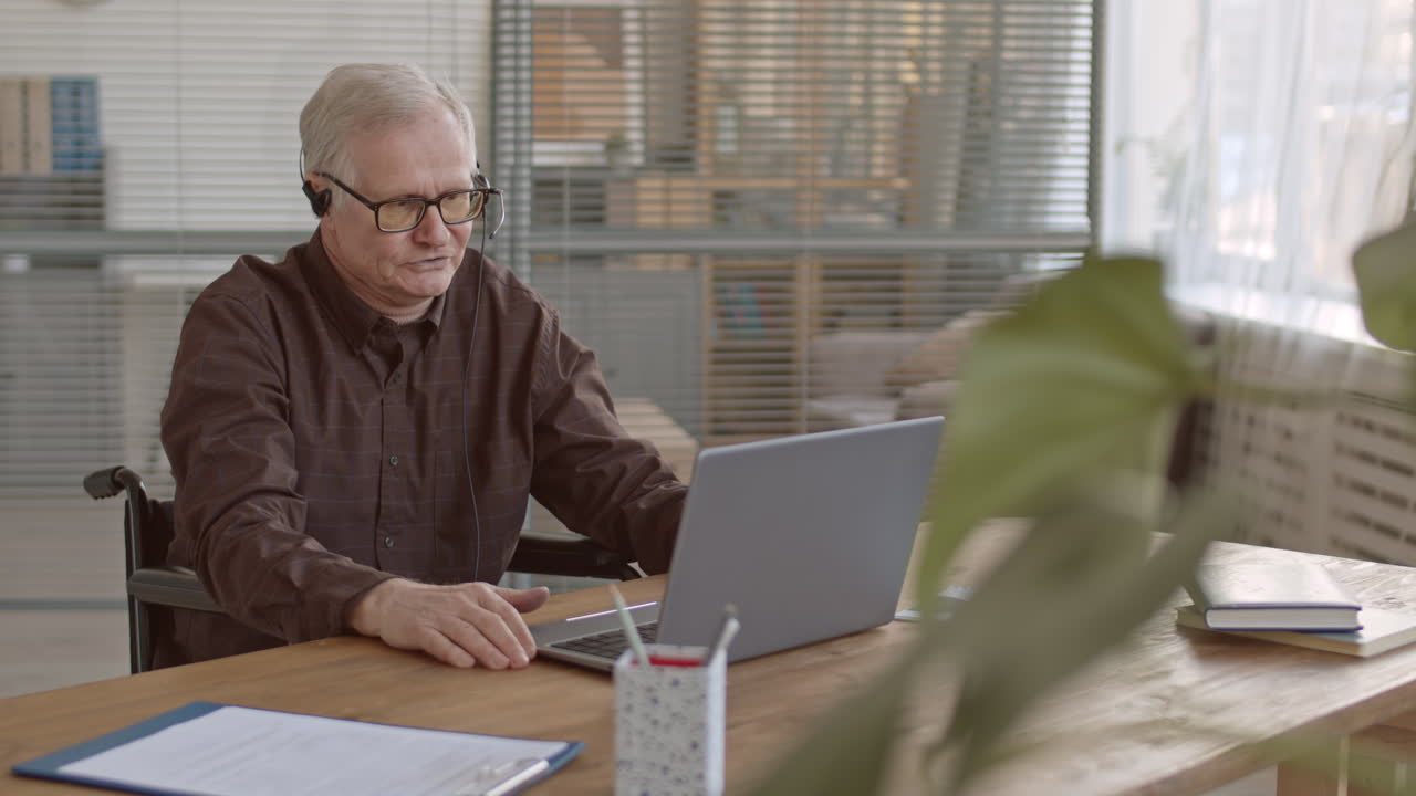 Senior Businessman Video Conferencing in Office