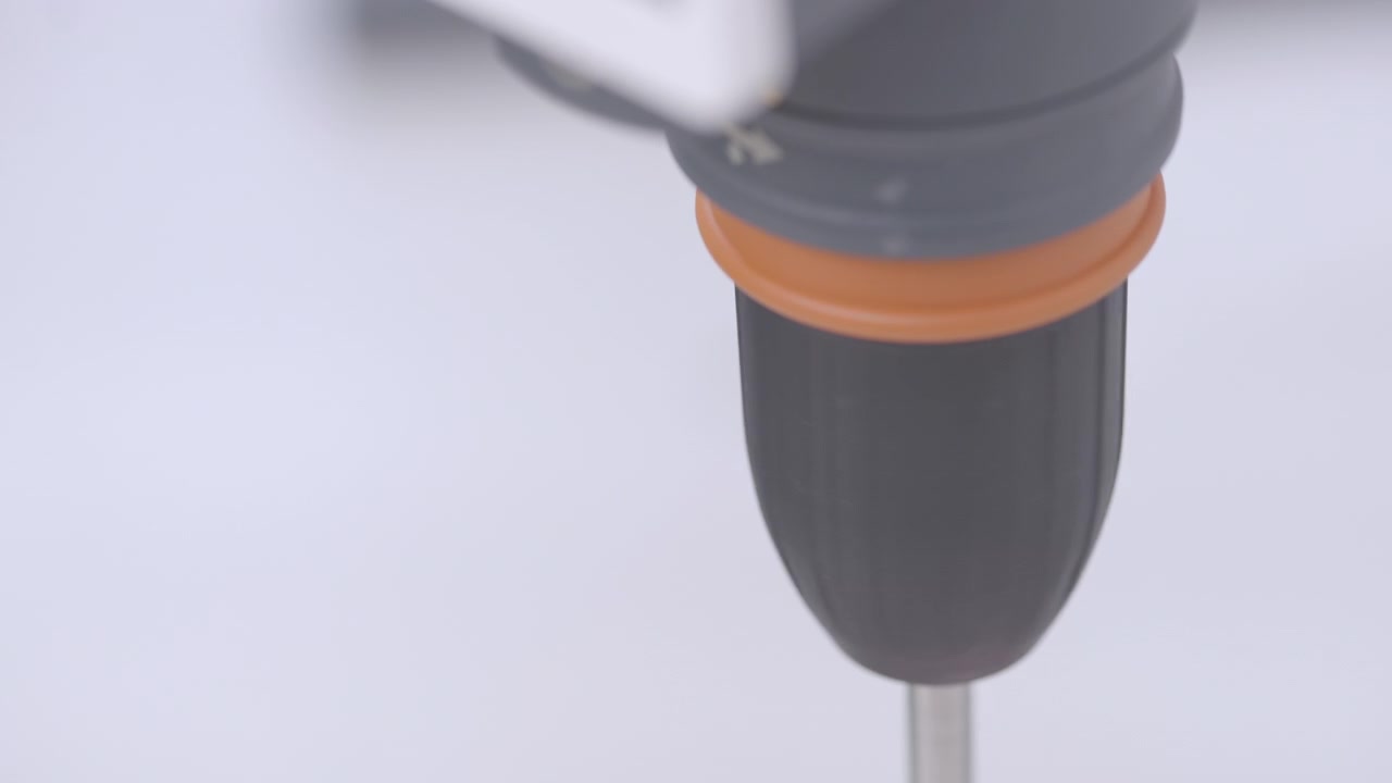 Close-up of a detailed view of the head of an industrial instrument or mixer, showing its rotating part with a black body and orange ring