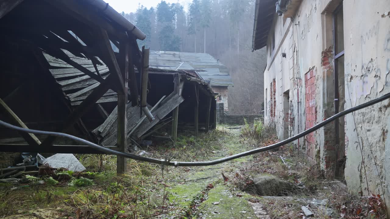 Collapsed decaying stark buildings of derelict abandoned sanatorium