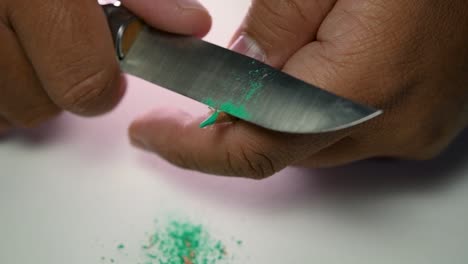 Footage-of-hands-slowly-sharpening-a-pencil-and-some-coloured-pencils-with-a-sharp-knife