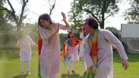 indian man throwing color at his wife in a holi event