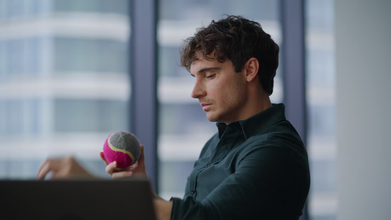 Business manager throwing ball sitting company workplace taking break closeup