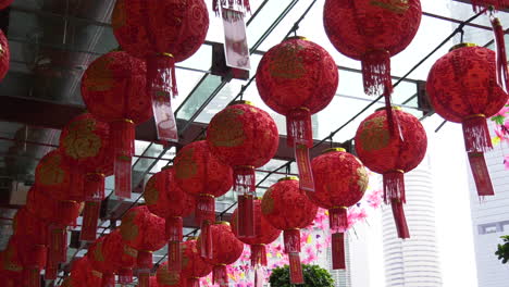 red lanterns and lucky charm blowing in the summer breeze at a temple in chinatown, singapore