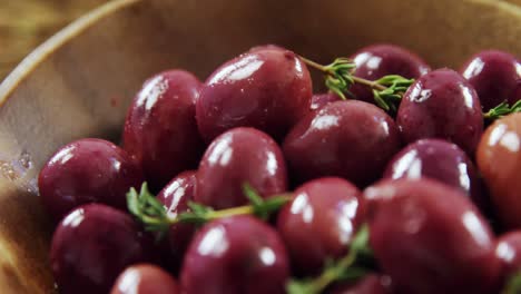 fresh red olives and rosemary in a bowl