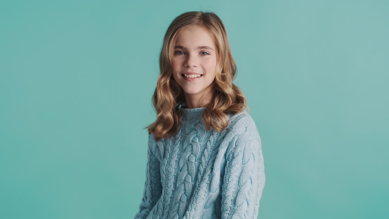 Happy teenage Caucasian girl in front of the camera.