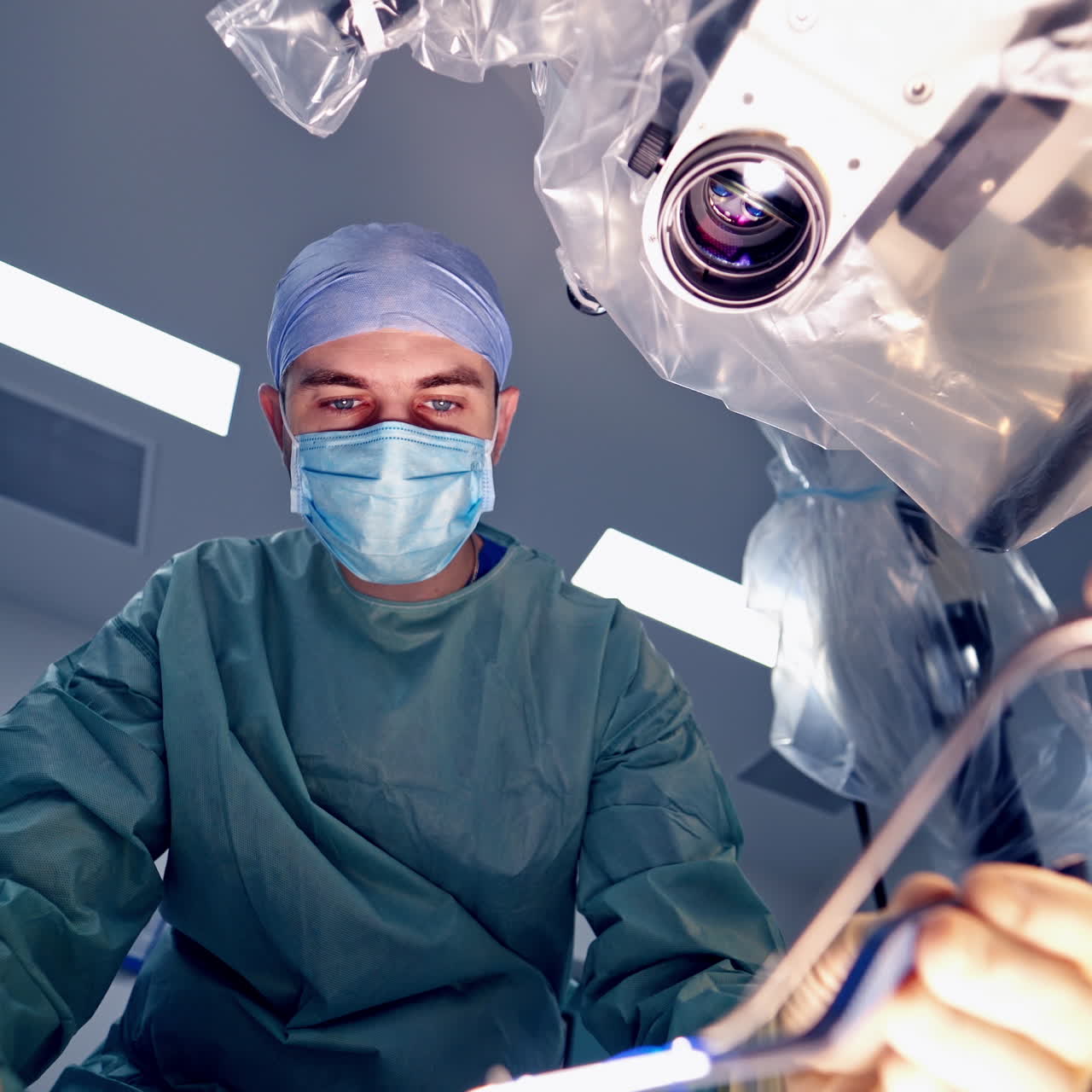 View from below of experienced surgeons with medical tools during operation