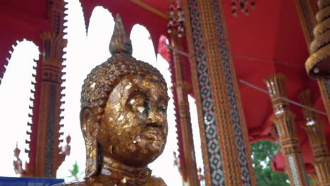 buddha statue head inside the temple in bangkok, thailand - slider right shot