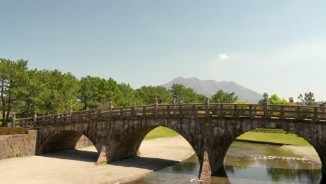 a beautiful park with a view of nishida bridge and sakurajima