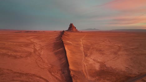 sunset scenery and ship rock stone formation in northwestern new mexico - aerial drone shot