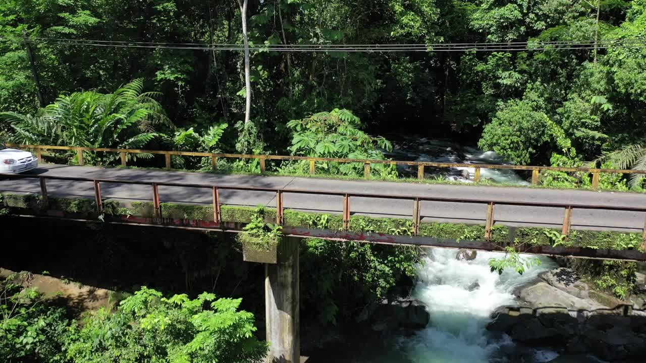 A car pass a bridge under a river