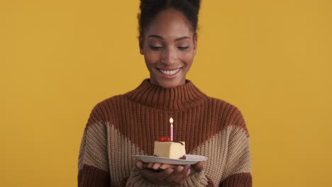 young woman celebrating birthday with cheesecake