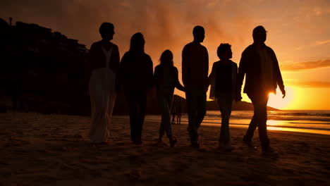 Sunset,-walk-and-silhouette-of-family-at-the-beach