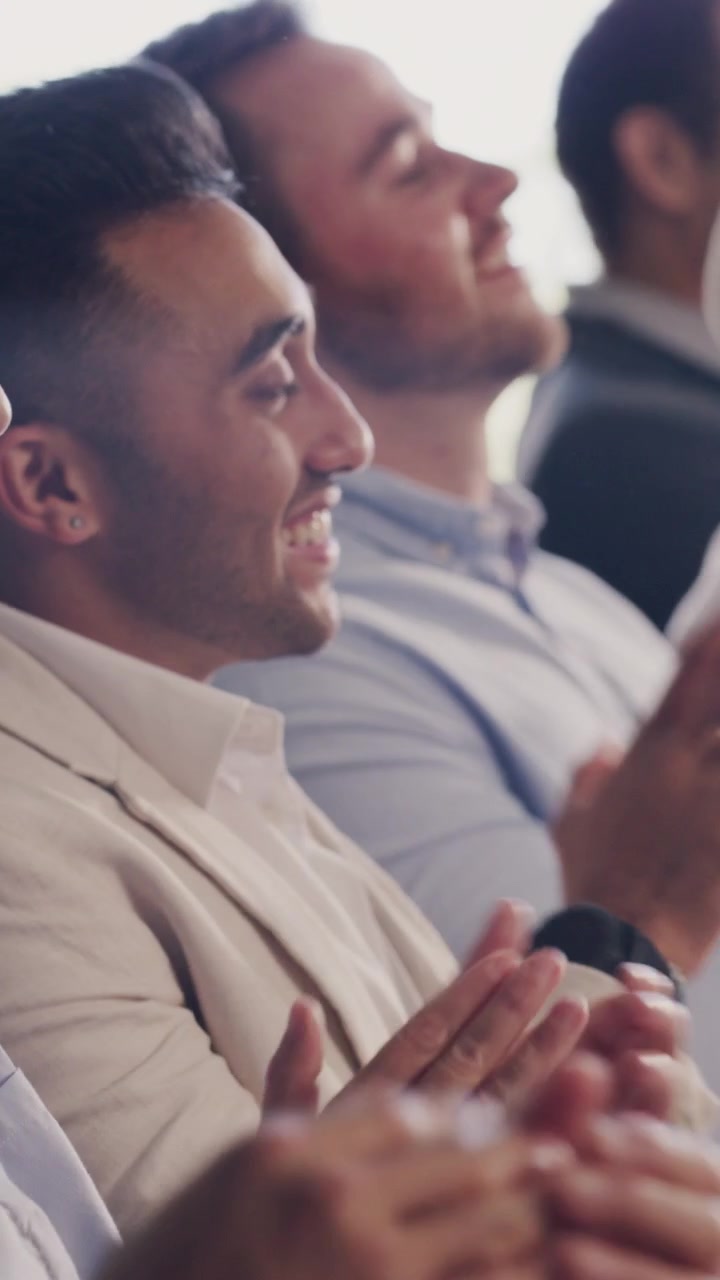Diverse Group of Professionals Applauding During a Business Conference