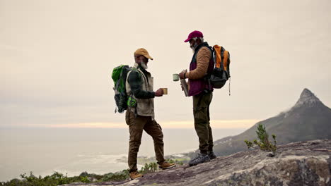 two mature men enjoying a break during a hike