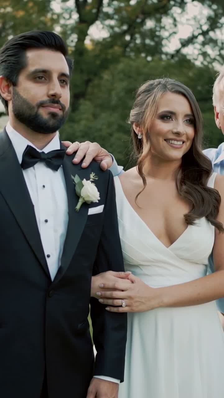 Happy Newlyweds Posing with Family Member at Outdoor Wedding