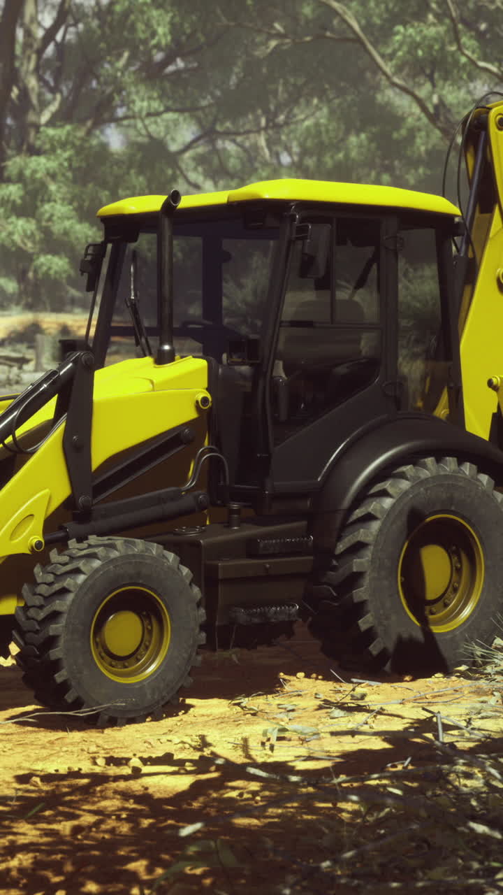 Heavy machinery clears land under bright sunlight in rugged terrain