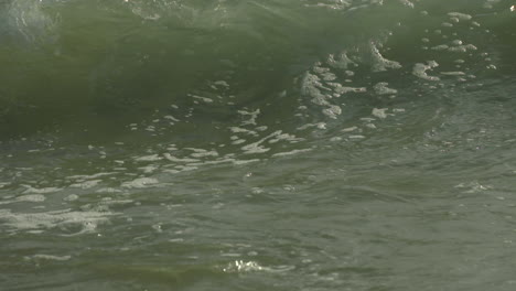 slow motion footage of a wave crashing into shore