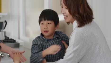 happy asian family dancing in kitchen children having fun dance with mother and father enjoying exciting weekend at home 4k footage