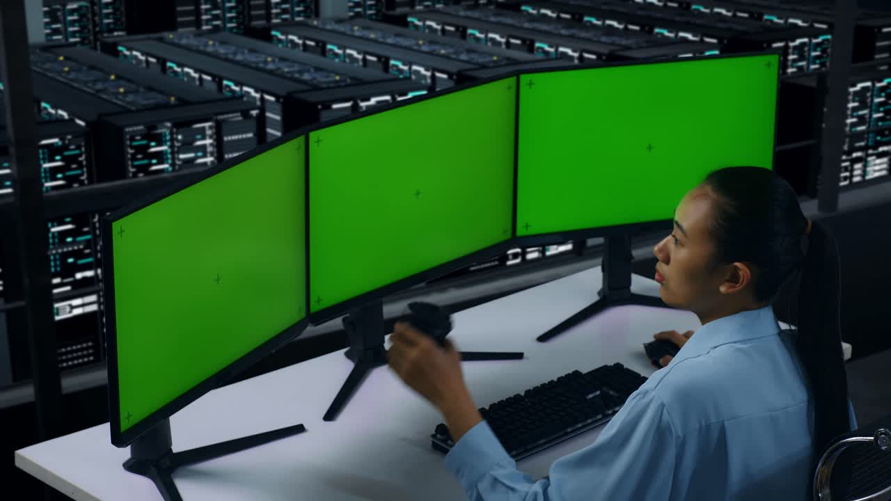 Side View Of Asian Woman Drinking Coffee And Working With Mock Up Multiple Computer Monitor In Data Center