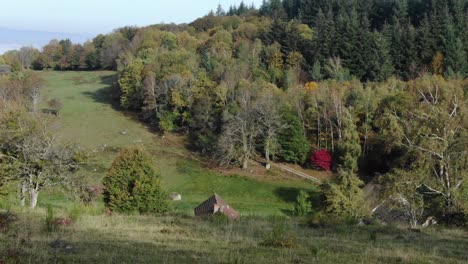 Drone-flying-low-in-Uchon-countryside-on-sunny-day,-France