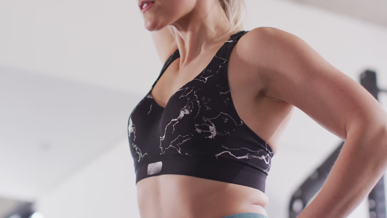 체육관에서 케틀벨 무게로 운동하는 단호한 백인 여성의 비디오