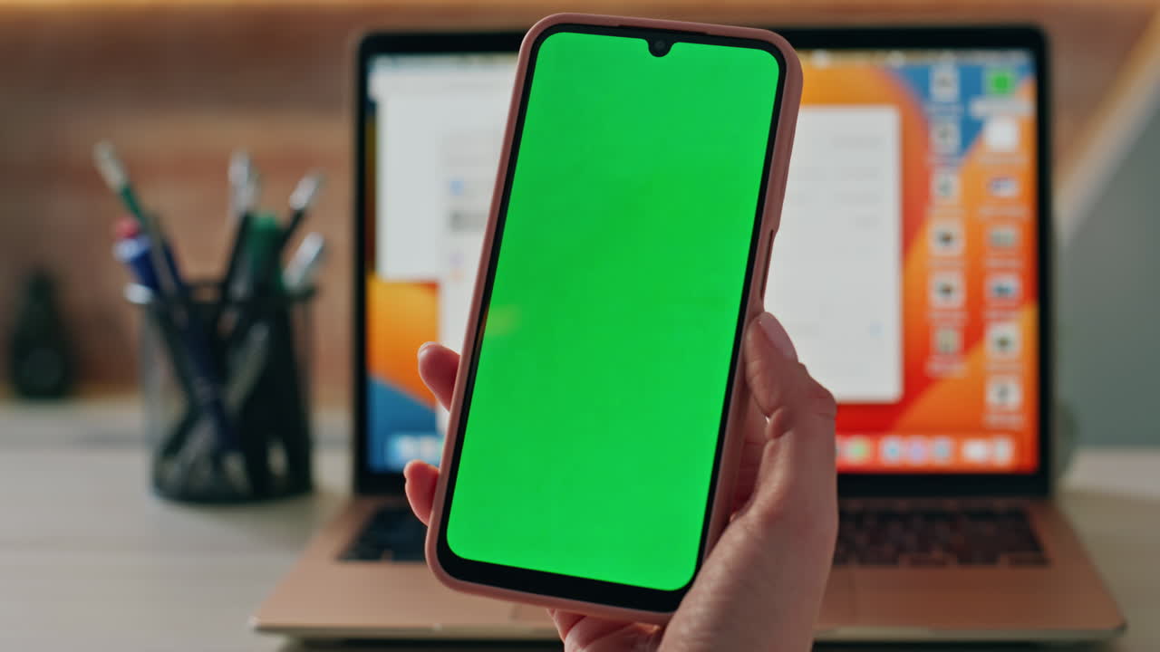 Consultant hands holding mockup cellphone at workplace close up. Woman browsing