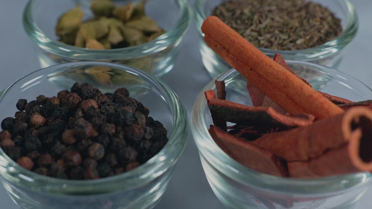 different types of indian whole spices or garam masala in small glass bowl, 4k, push in shot.