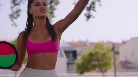 A woman exercising outdoors in a pink sports bra