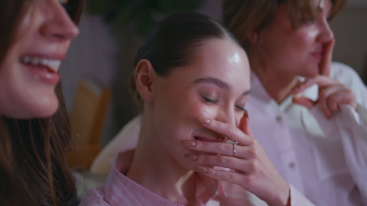 Overjoyed girls enjoying comedy at home hen party closeup. Laughing three women