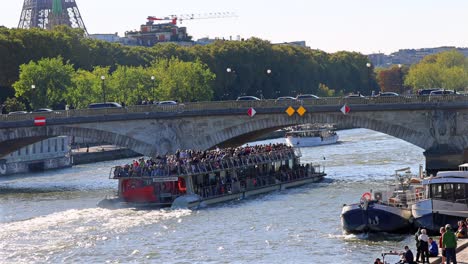 crowded tourist boat on the seine river in paris
