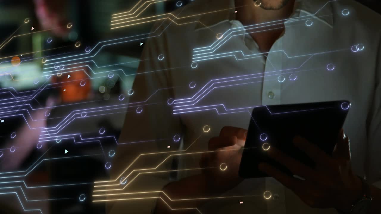 Man tapping tablet in tech office circuit overlay rising and filling badges while he checking data