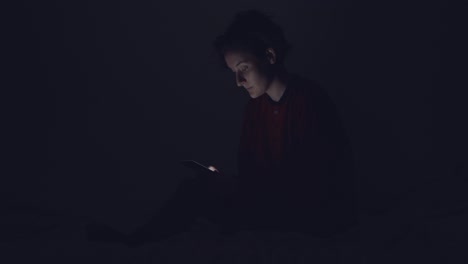 woman using phone in the dark