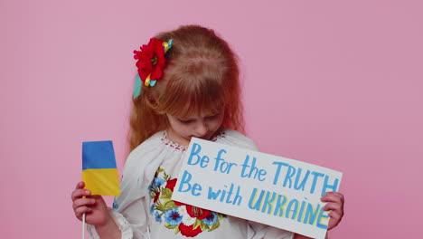 Upset-toddler-Ukrainian-girl-protesting-war-conflict-raises-inscription-massage-Hands-Off-Ukraine