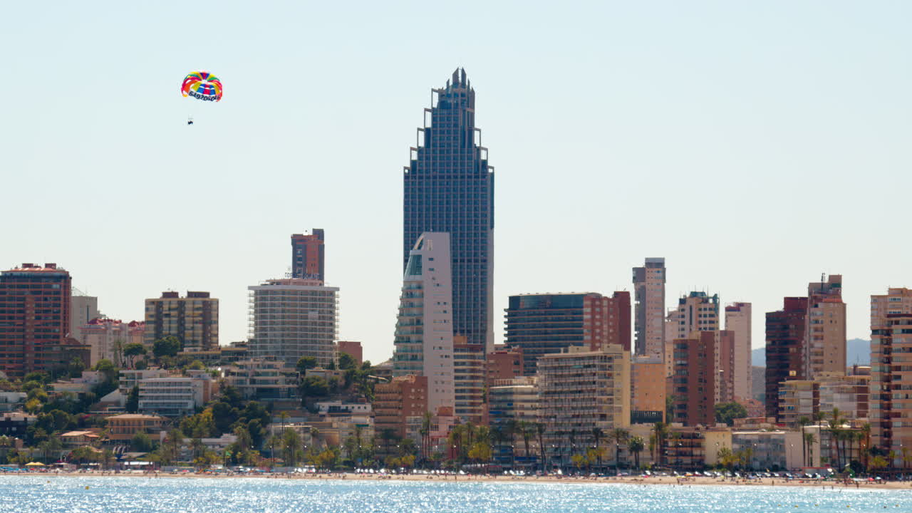 Parasailing over the bay with Benidorm's high rise skyline in the distance