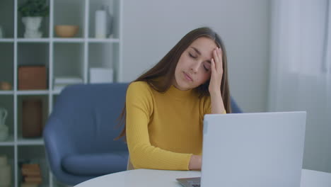 stressed frustrated businesswoman wearing suffering from headache at work. exhausted tensed worker coping with migraine emotional stress concept feeling pain sitting at office desk with laptop.