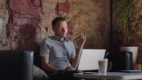 thoughtful serious young man student writer sit at home office desk with laptop thinking of inspiration search problem solution ideas lost in thoughts concept dreaming looking away