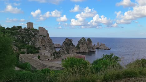 beautiful 4k footage of stacks or faraglioni of scopello in background, sicily