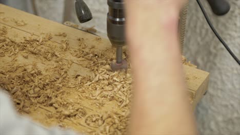 pillar drill being used to drill holes in white oak slab