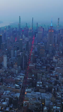 fascinating panorama of splendid new york in the coming evening. blue fog covering the metropolis at dusk. aerial view. vertical video