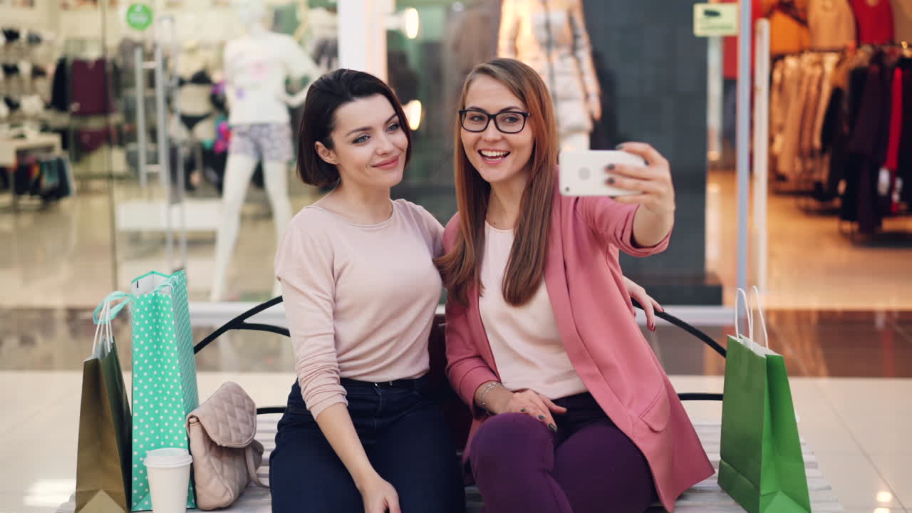 Two Women Taking a Selfie in a Shopping Mall