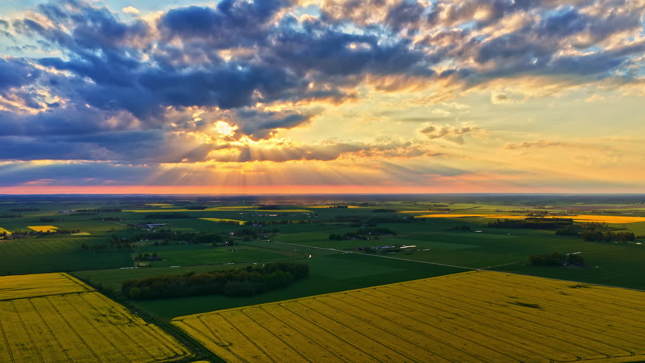 Beautiful Skies During Sunrise Over The Countryside, Canola Fields And Meadow. - aerial hyperlapse shot