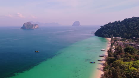tropical island beach with longtail boats