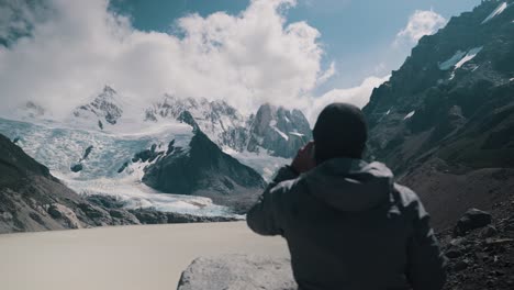 back view of a man with laguna torre, cerro torre and glacier in the background in el chalten, argentina