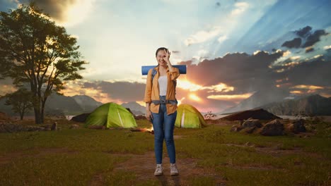 happy woman camping at sunset